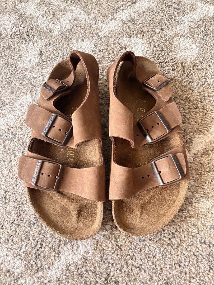 Auth Preloved Birkenstock Milano (Category: Slippers and slides) located in Paranaque City. Submitted by silentstone.dolphin (Listing ID 1463066284, Image 1). Description: Oiled Leather.. Brass Buckle.. Visible Print.. Size 37R.. Unisex.. Super Nice in Actual😍.
