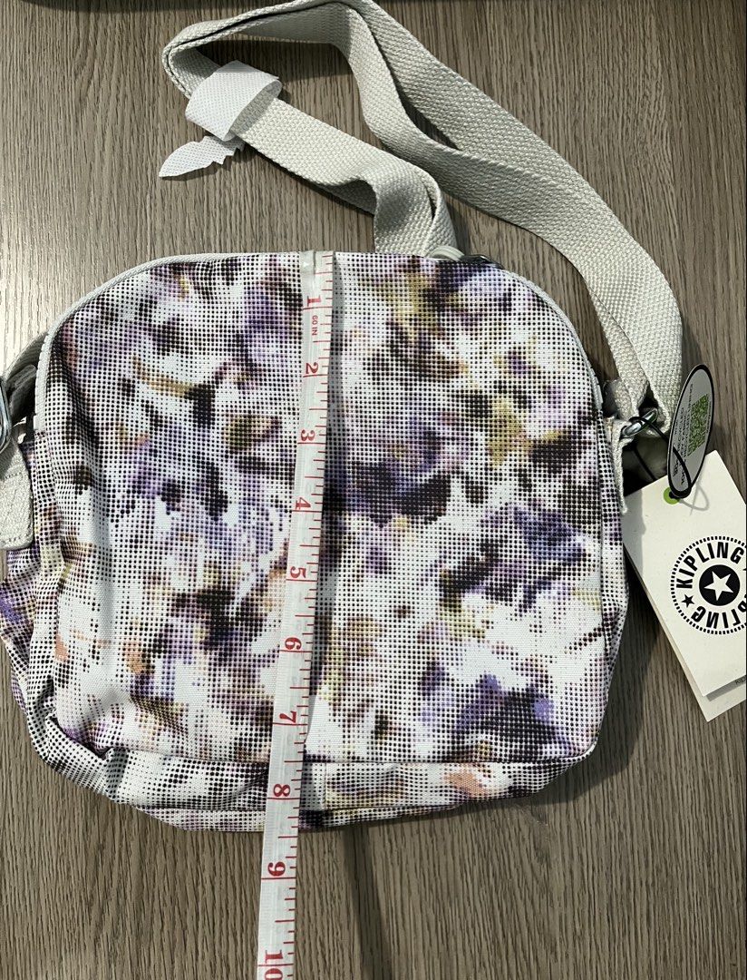 Authentic Kipling "Digi Pixel" Keefe Crossbody Bag (Category: Cross-body Bags) located in Paranaque City. Submitted by simonthecutecatboy (Listing ID 1463004551, Image 2). Description: - Cute Kipling crossbody bag - Fun 'Digi Pixel' print - Main zippered compartment - Front zippered pocket - Adjustable strap for comfortable wear - Includes original tags - Comes with signature Kipling monkey keychain - Approximate dimensions: 9" W x 7" H.