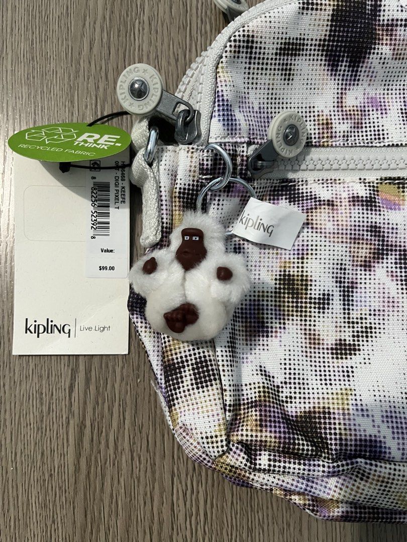 Authentic Kipling "Digi Pixel" Keefe Crossbody Bag (Category: Cross-body Bags) located in Paranaque City. Submitted by simonthecutecatboy (Listing ID 1463004551, Image 3). Description: - Cute Kipling crossbody bag - Fun 'Digi Pixel' print - Main zippered compartment - Front zippered pocket - Adjustable strap for comfortable wear - Includes original tags - Comes with signature Kipling monkey keychain - Approximate dimensions: 9" W x 7" H.