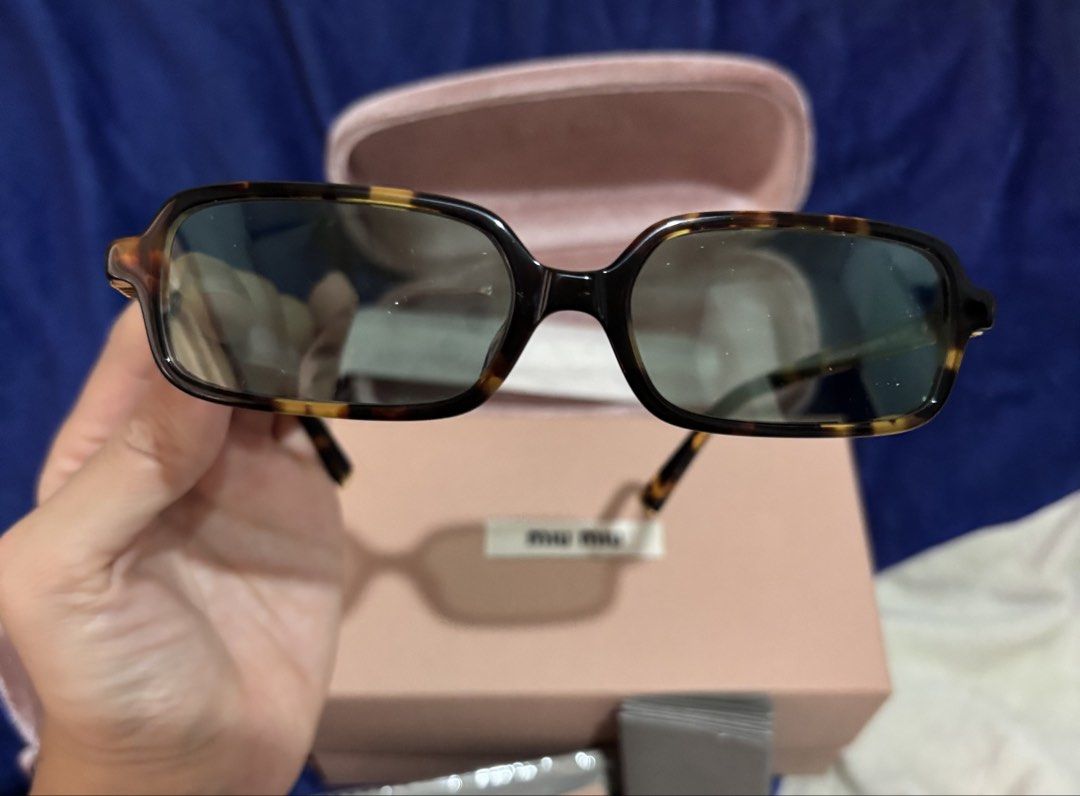 Authentic Miu Miu Regard Sunglasses (Category: Sunglasses & Eyewear) located in Taytay. Submitted by cel127 (Listing ID 1462946444, Image 3). Description: - Authentic Miu Miu sunglasses; bought from Prada Korea (1000000% authentic) - Tortoiseshell pattern frames; dark grey lenses - Includes original case, dust bag, cleaning cloth, authenticity cards (complete) - Original price online 370 euros~ Php 26,000 RFS: doesn’t suit my face shape, bought a