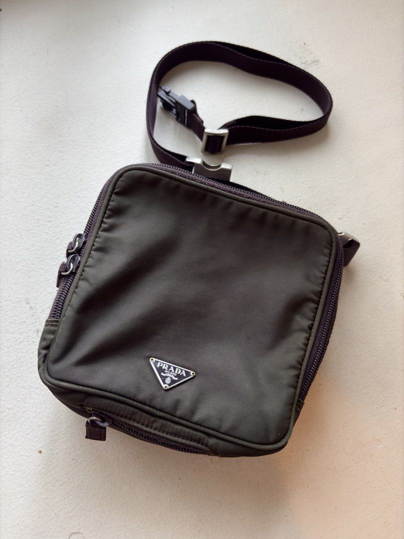 Authentic Prada Tessuto Nylon Multi-Utility Bag in Olive Green (Category: Luxury Bags & Wallets) located in Mandaluyong City. Submitted by wear_your_style (Listing ID 1462941669, Image 1). Description: Rare. Super nice. Bought preloved in Japan years ago. You may use this 3-way: puwede crossbody, handbag, or belt bag. Detachable sling. Ganda ng size, pa-square siya: 6X6 inches. But surprisingly marami ka malagay. It has 2 zipper compartments. Lam