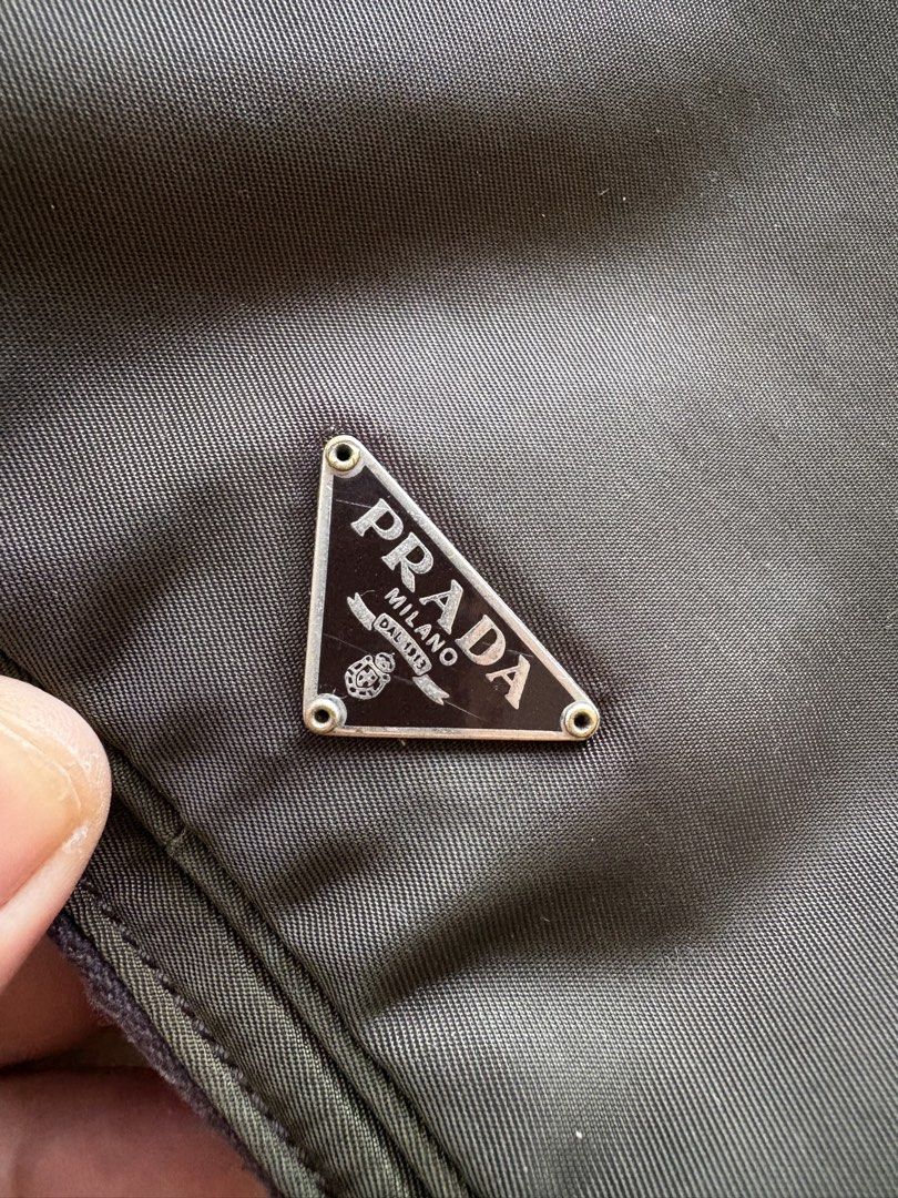 Authentic Prada Tessuto Nylon Multi-Utility Bag in Olive Green (Category: Luxury Bags & Wallets) located in Mandaluyong City. Submitted by wear_your_style (Listing ID 1462941669, Image 3). Description: Rare. Super nice. Bought preloved in Japan years ago. You may use this 3-way: puwede crossbody, handbag, or belt bag. Detachable sling. Ganda ng size, pa-square siya: 6X6 inches. But surprisingly marami ka malagay. It has 2 zipper compartments. Lam