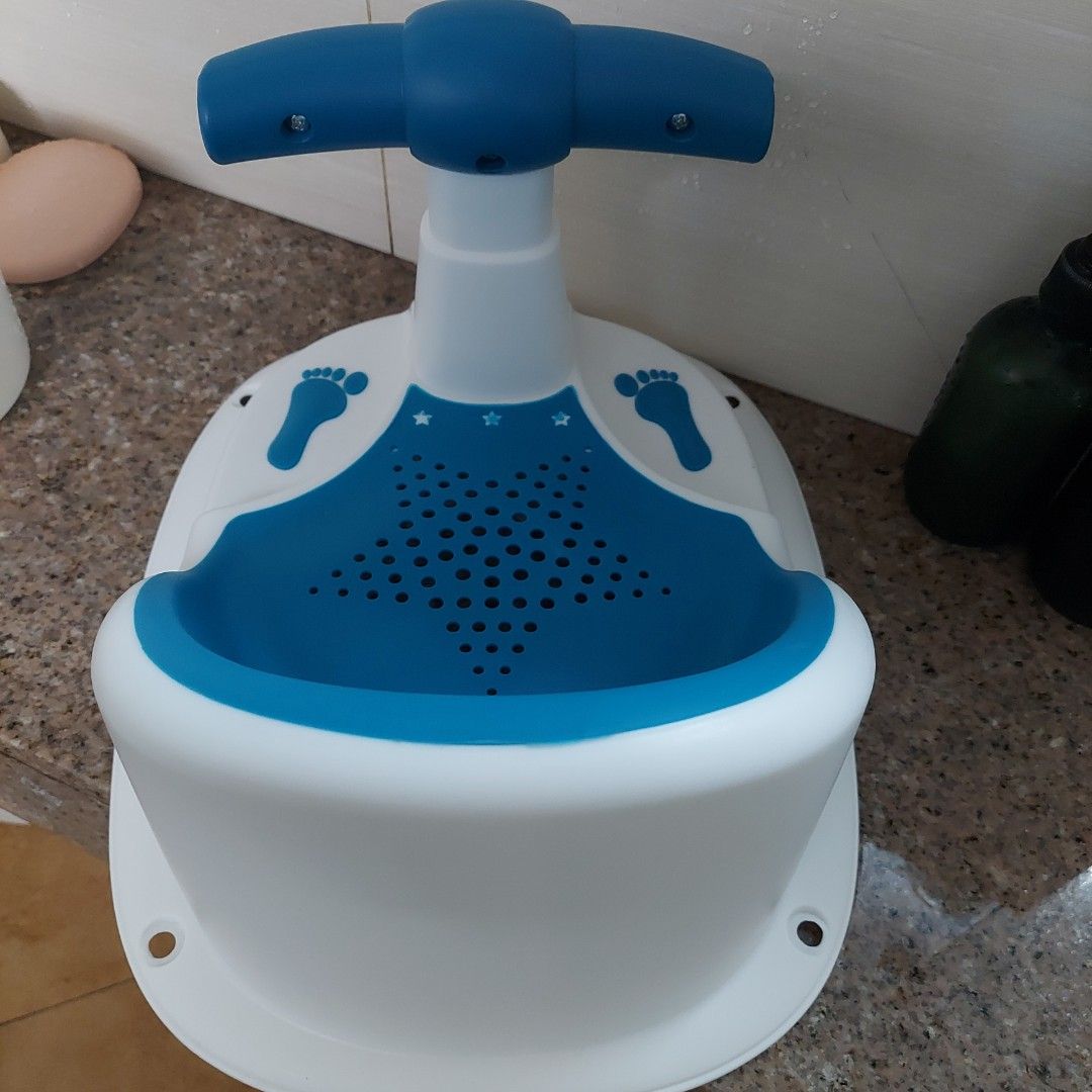 Baby Bath Seat with Handle and Footprints (Category: Bathtub & Bath Accessories) located in Manila. Submitted by mommiedeclutter (Listing ID 1462890063, Image 2). Description: - Blue and white baby bath seat - Safety handle in the front - Cute footprint details on the sides - Drainage holes in the seat - Makes bath time easier and safer - Easy to clean RFS: baby prefers to stand while bathing .