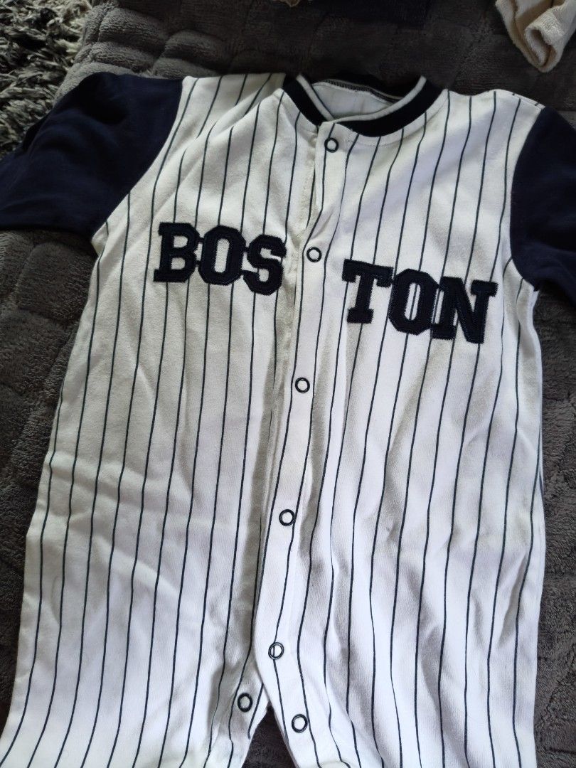 Baby Boston Baseball Romper 12 Months (Category: Babies & Kids Fashion) located in Tarlac. Submitted by momma02 (Listing ID 1462915347, Image 1). Description: - Adorable white baby romper with navy pinstripes. - Features 'BOSTON' text across the chest in navy. - Contrasting navy sleeves and collar. - Convenient snap closures on front and crotch for easy diaper changes. - Made from soft and breathable 100% cotton. - Tagged as 12 months size..