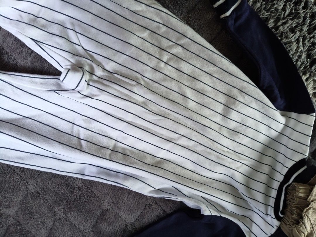 Baby Boston Baseball Romper 12 Months (Category: Babies & Kids Fashion) located in Tarlac. Submitted by momma02 (Listing ID 1462915347, Image 3). Description: - Adorable white baby romper with navy pinstripes. - Features 'BOSTON' text across the chest in navy. - Contrasting navy sleeves and collar. - Convenient snap closures on front and crotch for easy diaper changes. - Made from soft and breathable 100% cotton. - Tagged as 12 months size..