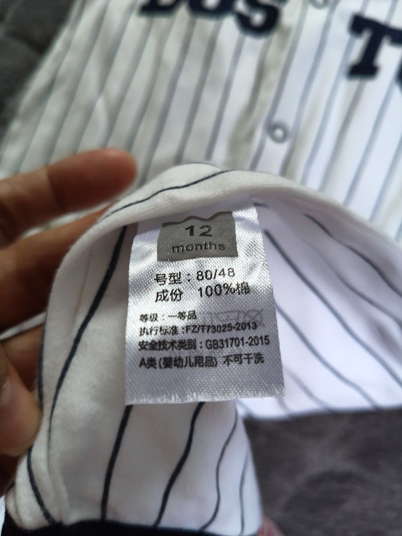 Baby Boston Baseball Romper 12 Months (Category: Babies & Kids Fashion) located in Tarlac. Submitted by momma02 (Listing ID 1462915347, Image 2). Description: - Adorable white baby romper with navy pinstripes. - Features 'BOSTON' text across the chest in navy. - Contrasting navy sleeves and collar. - Convenient snap closures on front and crotch for easy diaper changes. - Made from soft and breathable 100% cotton. - Tagged as 12 months size..