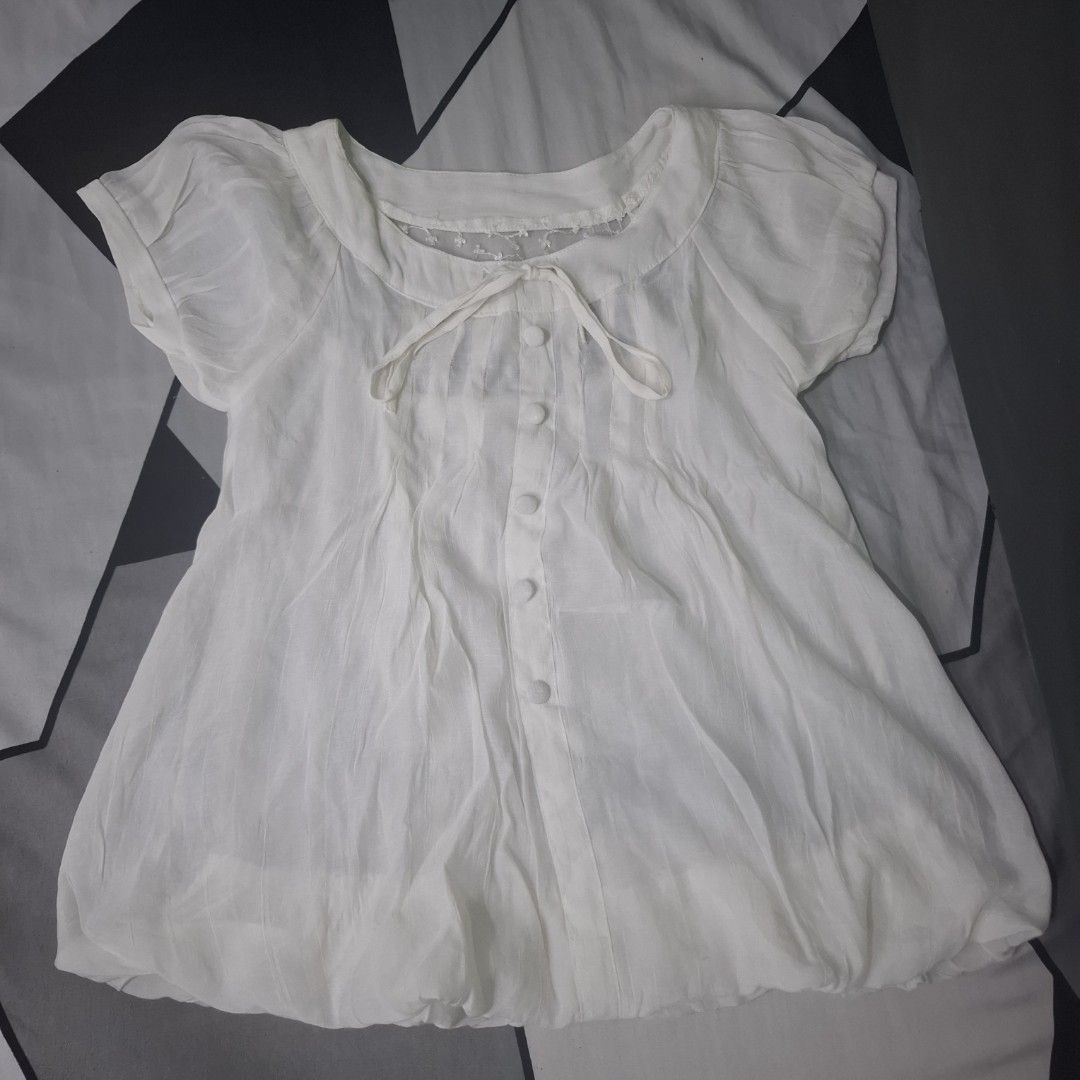 Baby doll top (Category: Activewear) located in Adams. Submitted by frog_and_clover (Listing ID 1462922802, Image 1). Description: white baby doll top lace back, kinda see through sa loob, need inner wear if susuot. super cute. what you see is what you get. can fit extra small to small size.