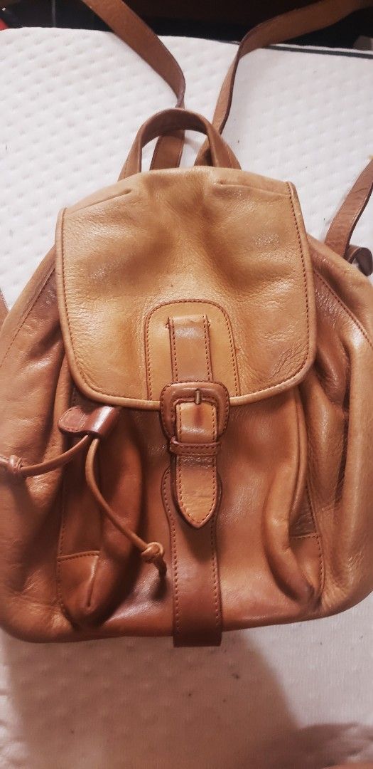 Bally Leather Backpack Tan (Category: Backpacks) located in Marikina City. Submitted by racoon143 (Listing ID 1462903205, Image 1). Description: - Bally tan leather backpack - Classic buckle flap closure with drawstring underneath - Adjustable straps - Interior zippered pocket and main compartment - Shows some signs of wear on leather and hardware.