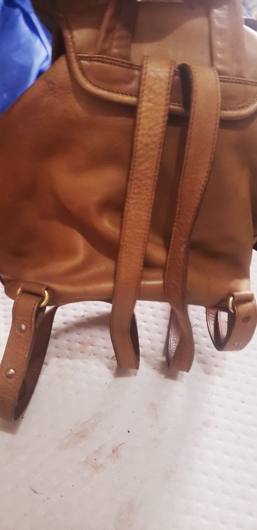 Bally Leather Backpack Tan (Category: Backpacks) located in Marikina City. Submitted by racoon143 (Listing ID 1462903205, Image 3). Description: - Bally tan leather backpack - Classic buckle flap closure with drawstring underneath - Adjustable straps - Interior zippered pocket and main compartment - Shows some signs of wear on leather and hardware.