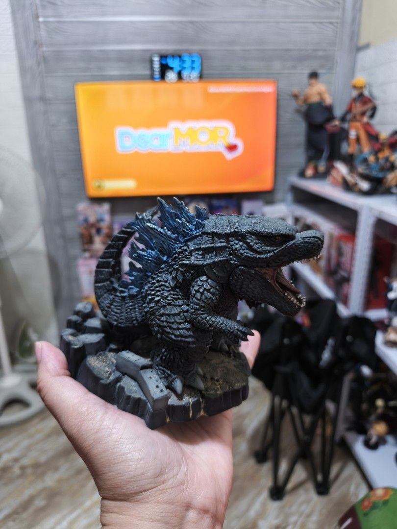 Banpresto Godzilla (2019) Deformation King (Category: Figurines & Statues) located in Caloocan City. Submitted by drmj21 (Listing ID 1462978105, Image 1). Description: Manufacturer: Bandai Banpresto Style: Deformed or stylized "chibi" design with a large head and compact body Features: Textured black scales, glowing blue dorsal plates, and a rubble-themed display base Material: Molded PVC.