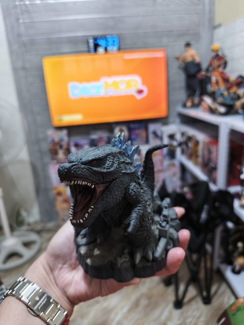 Banpresto Godzilla (2019) Deformation King (Category: Figurines & Statues) located in Caloocan City. Submitted by drmj21 (Listing ID 1462978105, Image 2). Description: Manufacturer: Bandai Banpresto Style: Deformed or stylized "chibi" design with a large head and compact body Features: Textured black scales, glowing blue dorsal plates, and a rubble-themed display base Material: Molded PVC.