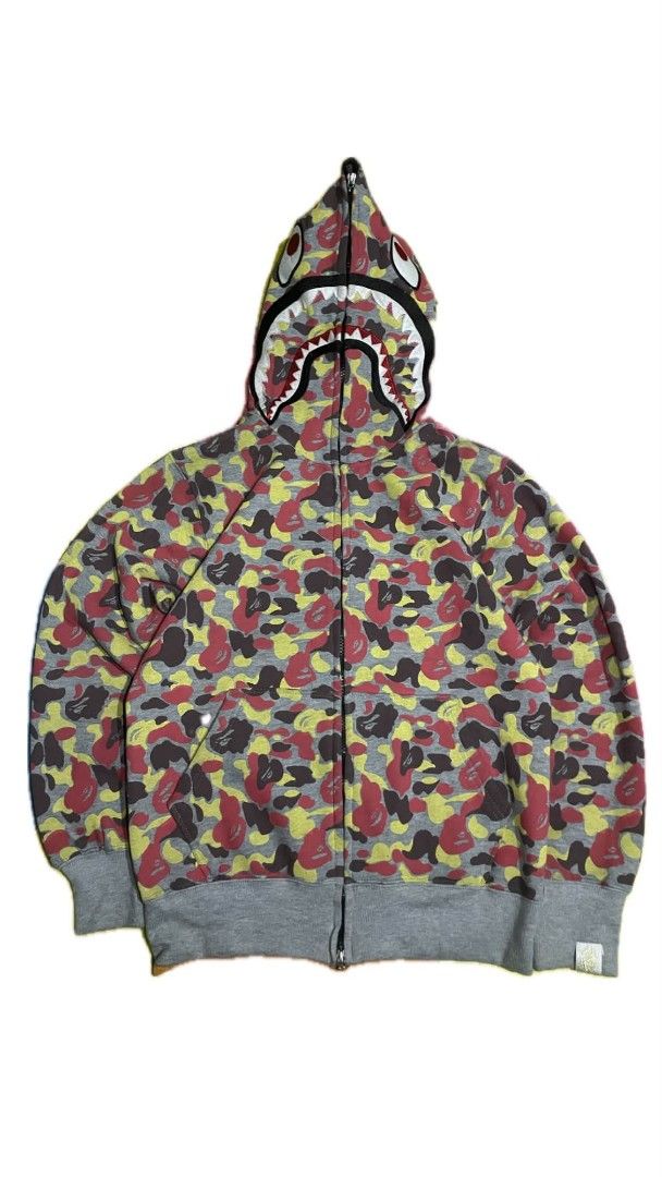BAPE Full Zip Shark Hoodie Camo (Category: Hoodies) located in Las Pinas. Submitted by akositroyvhaha (Listing ID 1462923741, Image 1). Description: - Classic BAPE shark hoodie - Iconic camo pattern (red, yellow, brown tones) - Full zip closure - Grey ribbed cuffs and hem - Perfect statement piece for streetwear enthusiasts.