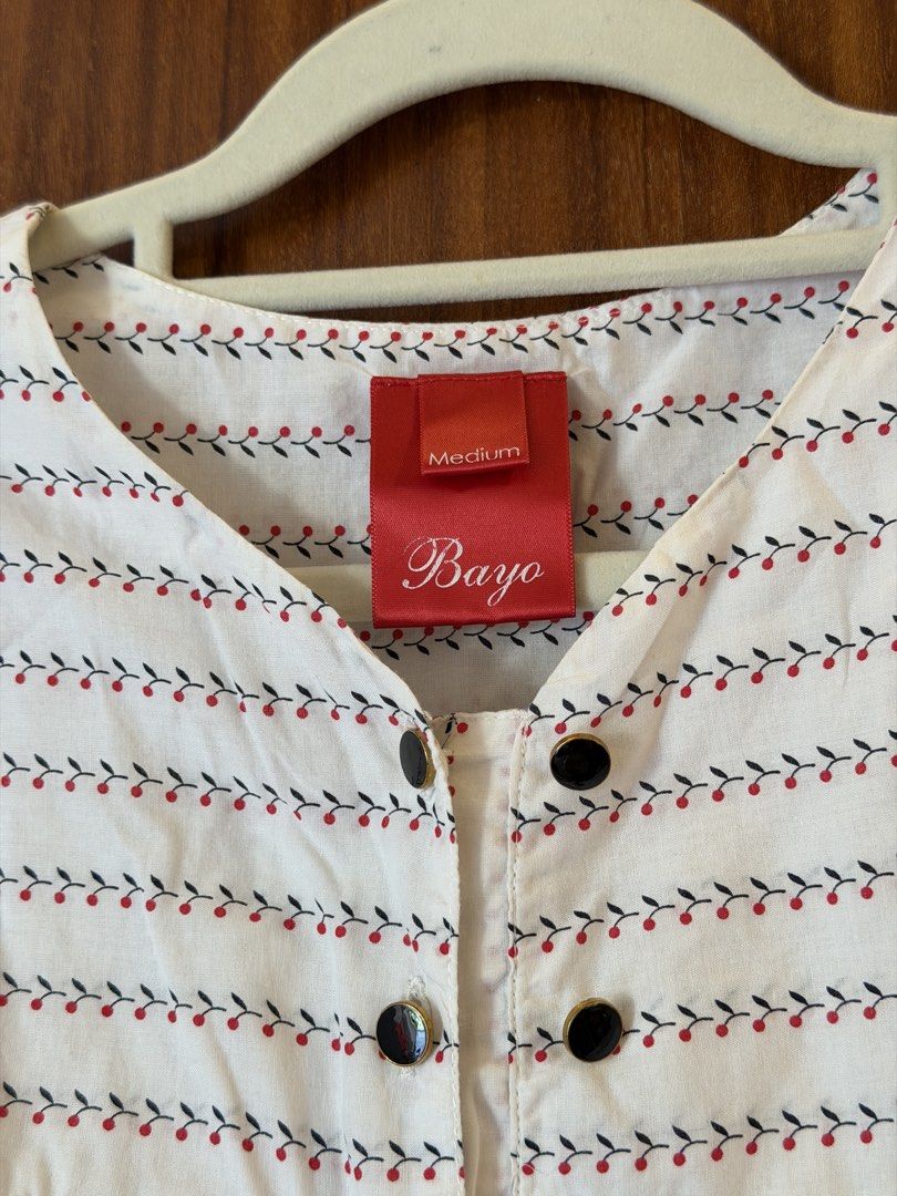 Bayo White Sleeveless Top with Red & Black Leaf Pattern (Category: Sleeveless) located in Bulacan. Submitted by preloved_bygrace (Listing ID 1462984735, Image 2). Description: - White sleeveless top from Bayo - Size: Medium - Adorable red and black leaf pattern - Button-up front with black buttons - Gathered detail at the bust Note: Color may vary due to lighting. RFS: decluttering, need funds *Buyer shoulders the SF (J&T or Lalamove) **Can offer