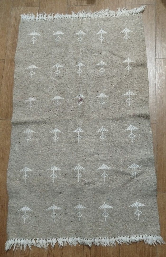 Beige Rug with White Geometric Pattern and Tassels (Category: Carpets, Mats & Flooring) located in Imus. Submitted by stop_shop7 (Listing ID 1463012498, Image 1). Description: - Beige rug with a repeating white geometric pattern. - Features white tassels on both ends. - Ideal as a throw rug or small accent rug. - Note: Small reddish stain visible in the center. - Adds great texture to any room..