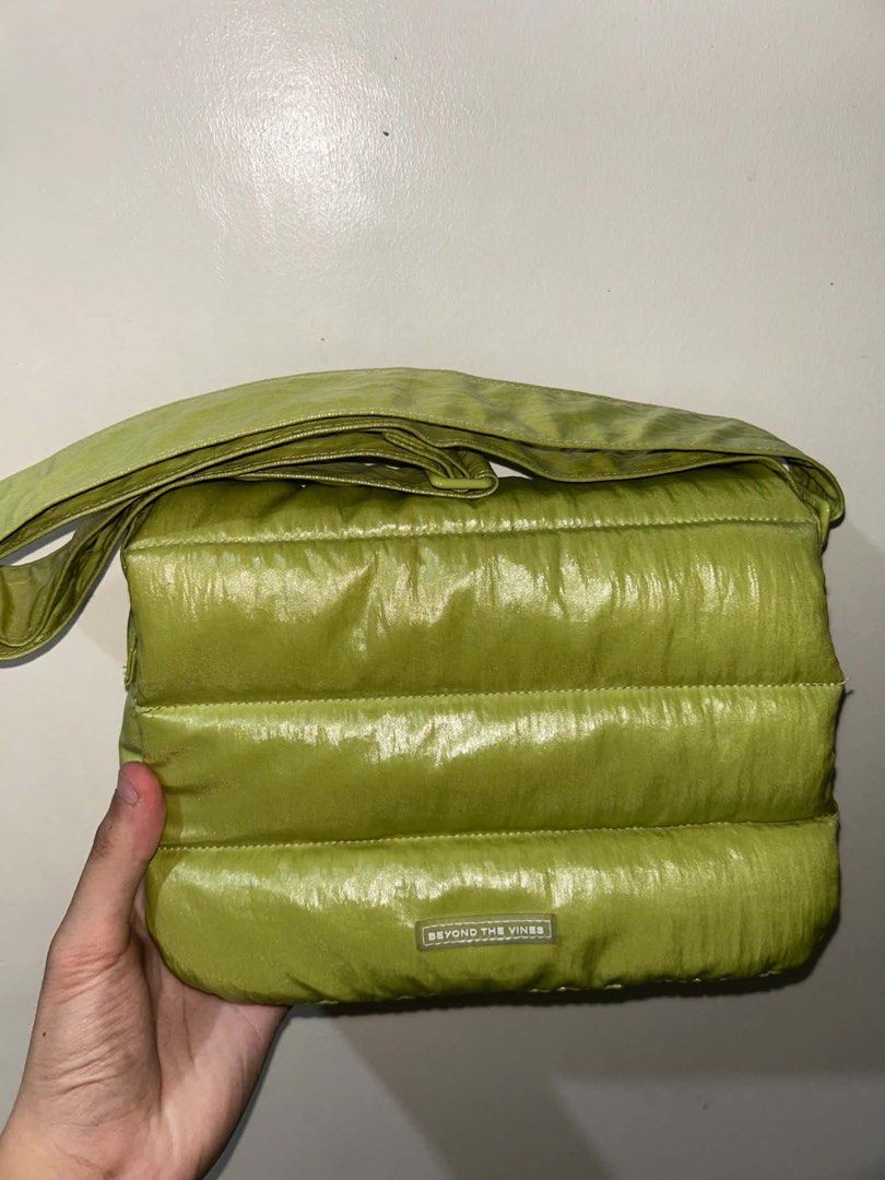 Beyond The Vines Puffer Bag Lime Green (Category: Cross-body Bags) located in Silang. Submitted by salmonellie (Listing ID 1463059102, Image 1). Description: Brand: Beyond The Vines - Lime green puffer crossbody bag - Bought for 5k last December 2025 in Rockwell - Complete with Dust Bag - Shiny material - Adjustable strap - Zip closure for main compartment - Blue interior.