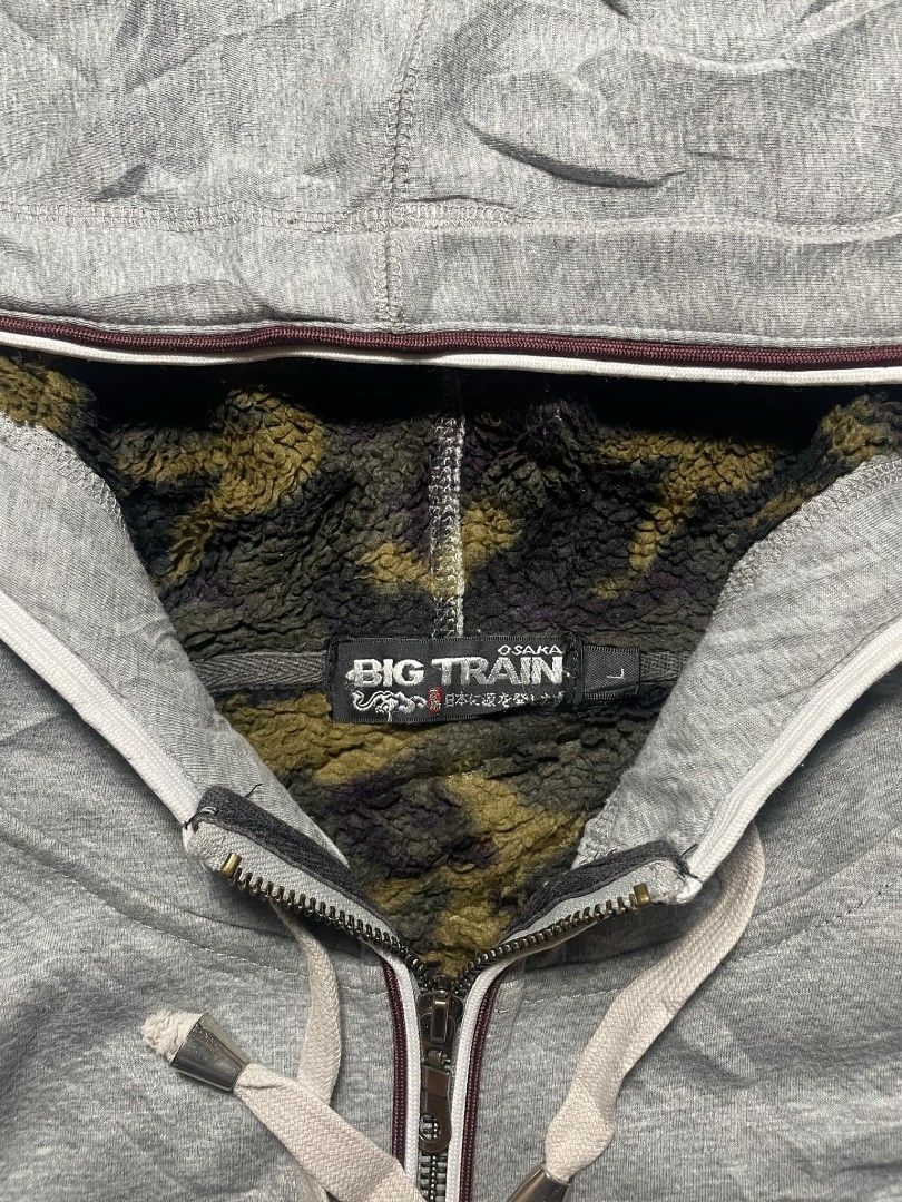 BIG TRAIN Grey Zip-Up Hoodie with Camo Lining (Category: Hoodies) located in Ligao. Submitted by merjudioma64633 (Listing ID 1463009685, Image 2). Description: - Grey zip-up hoodie from BIG TRAIN - Cool camouflage lining inside the hood - Embroidered design on the front - Size: Large (L) - Ideal for casual everyday wear.