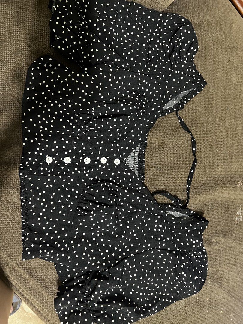 Black and White Polka Dot Crop Top with Buttons (Category: Blouses) located in Valenzuela. Submitted by decluttering.manila (Listing ID 1462914696, Image 1). Description: - Adorable black crop top with classic white polka dots. - Flattering V-neckline with functional button details down the front. - Smocked elastic panel at the back ensures a comfortable and secure fit. - Charming short puff sleeves with elastic cuffs. - Adjustable shoulder ties 