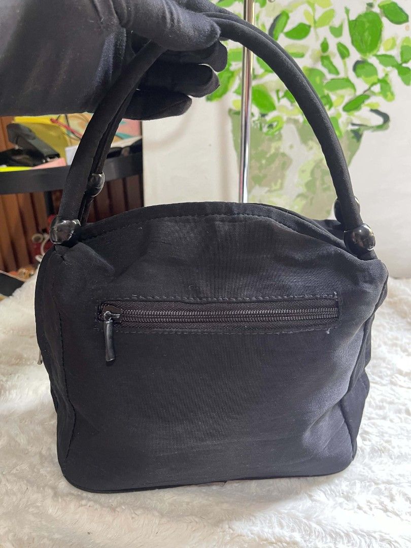 Black Beaded Floral Handbag with Zipper Closure (Category: Tote Bags) located in Naawan. Submitted by twilly.apparel2 (Listing ID 1462906018, Image 3). Description: - missing 1 puller Cute black handbag - Beaded floral embroidery on front - Top zipper closure - Zippered pocket on back - Lined interior with small pocket - Decorative beaded handles - Ideal for night outs or special occasions.