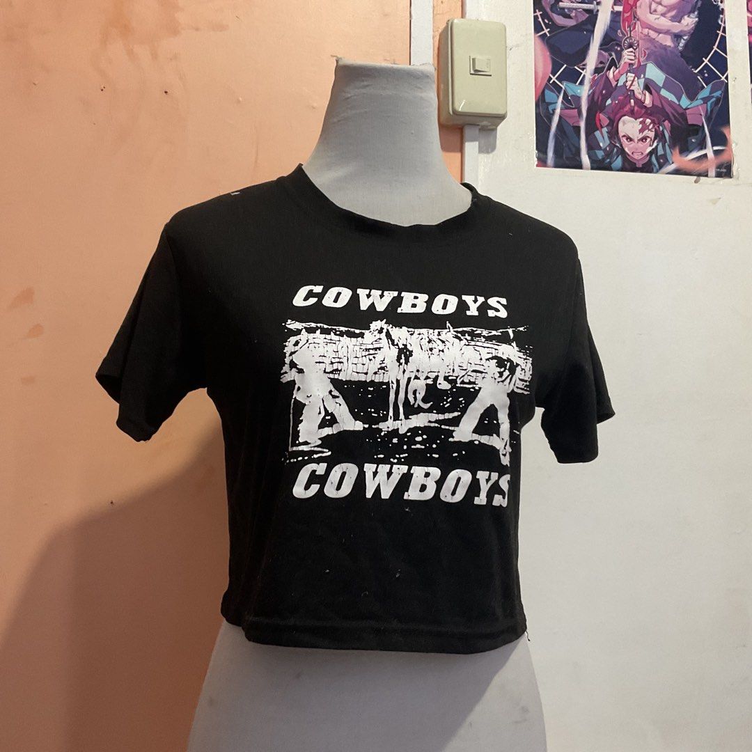 Black Cowboys Graphic Crop Top (Category: Shirts) located in Naga. Submitted by asrid.32 (Listing ID 1462954005, Image 1). Description: - Black crop top - Features 'Cowboys' text and distressed cowboy graphic - Short sleeves - Cropped fit - Ideal for a casual, edgy look - Versatile: pairs well with jeans or shorts.