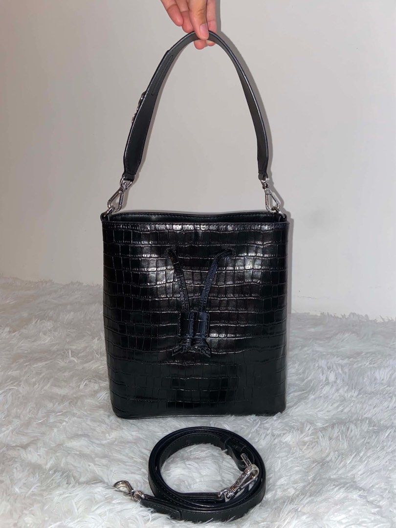 Black Croc Embossed Bucket Bag with Silver Hardware (Category: Luxury Bags & Wallets) located in Bulacan. Submitted by bella.ken.varietystore (Listing ID 1463096528, Image 1). Description: Chic black croc-embossed bucket bag with drawstring closure. Features a top handle, detachable crossbody strap, and silver hardware. Perfect for day or night, fits all your essentials..
