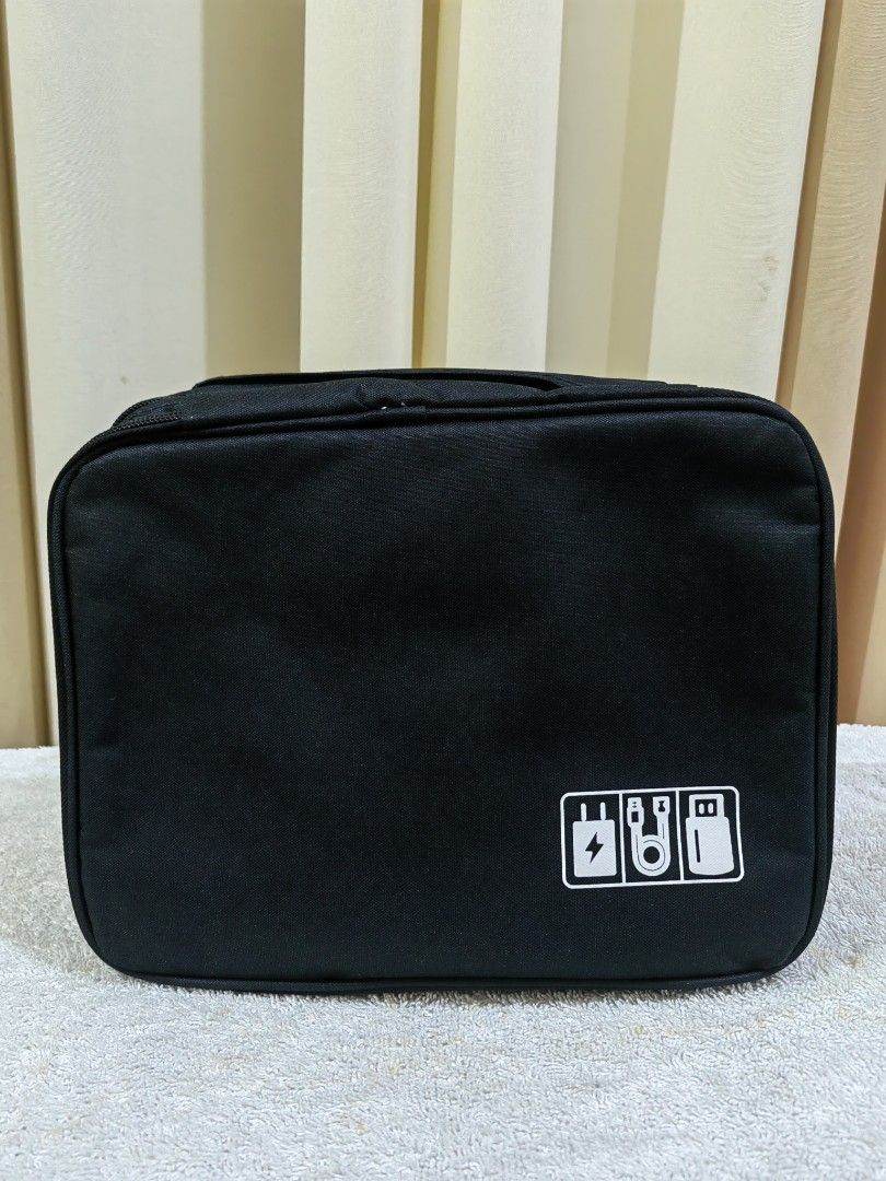 Black Electronics Organizer Bag for Cables and Accessories (Category: Accessory Holder, Box & Organizers) located in Makati City. Submitted by prelovedtreatedwithlove (Listing ID 1462912231, Image 1). Description: - Black organizer bag for tech accessories - Multiple compartments and elastic straps - Keeps cables, chargers, and small electronics tidy - Zipper closure - Ideal for travel or desk organization - Compact size Brand new A-035.