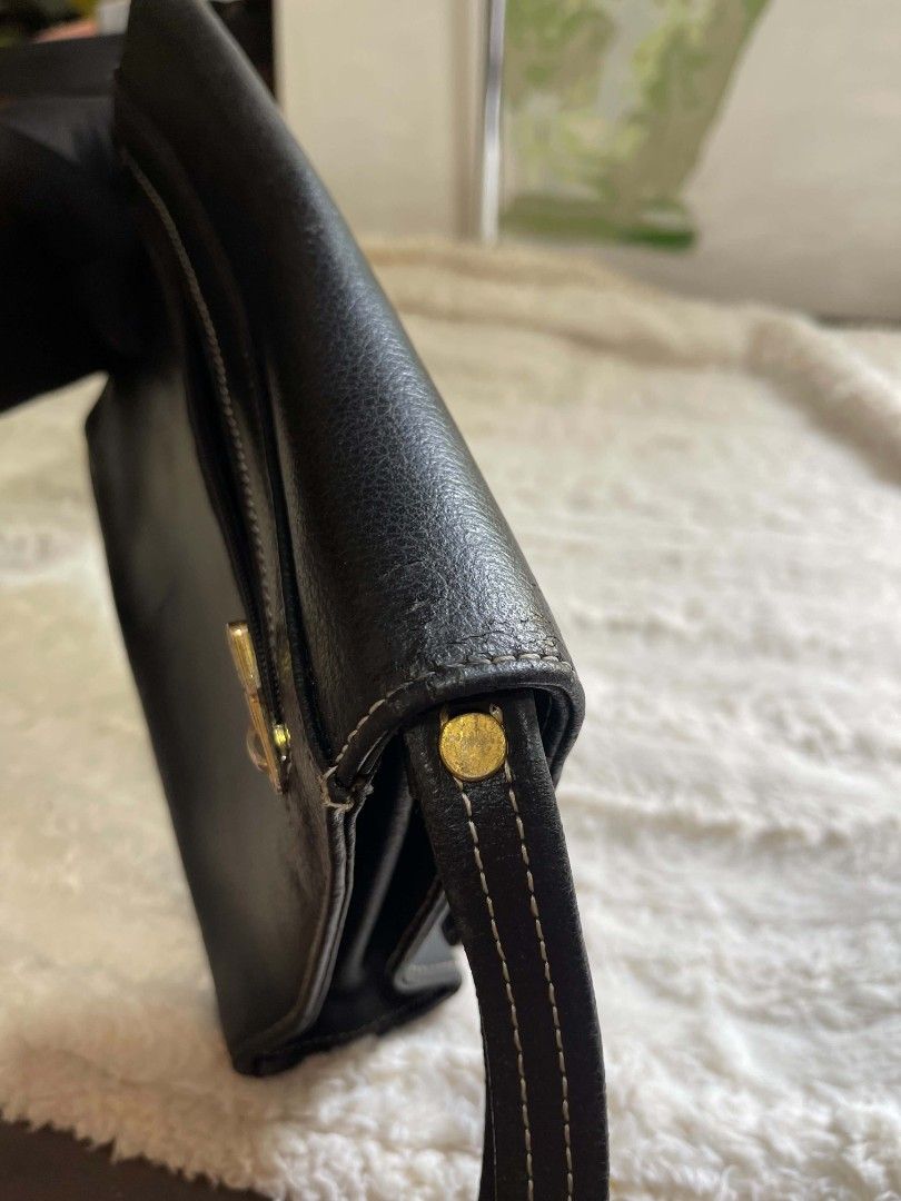 Black Leather Clutch Bag with Plaid Accent (Category: Belt bags, Clutches and Pouches) located in Naawan. Submitted by twilly.apparel2 (Listing ID 1462917759, Image 3). Description: - issue crack sa leather sa loob and sa labas Sleek black leather clutch - Elegant plaid ribbon accent on the front - Classic white stitching detail throughout - Convenient small wrist strap included - Secure side zipper closure - Measures approximately 8 inches wide.