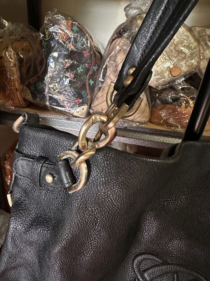 Black Leather Sling Bag (Category: Luxury Bags & Wallets) located in Butuan. Submitted by slownsteady_ (Listing ID 1463005312, Image 3). Description: - Authentic Loewe hobo bag in black leather - Luxurious pebbled leather texture - Elegant gold chain detailing - Comfortable leather straps - Secure top zipper closure - Ample interior space for essentials - Ideal everyday bag.
