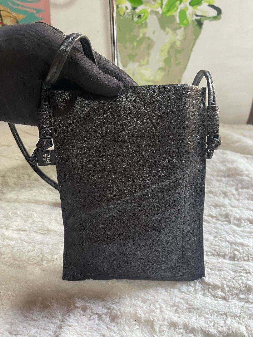 Black Leather Phone Pouch Bag (Category: Purses & Pouches) located in Naawan. Submitted by twilly.apparel2 (Listing ID 1462960429, Image 3). Description: - black leather phone pouch bag - Long, adjustable strap for crossbody or shoulder wear - Small and compact: Measures approx. 7" tall x 4" wide - Ideal for carrying essentials on quick errands or nights out.