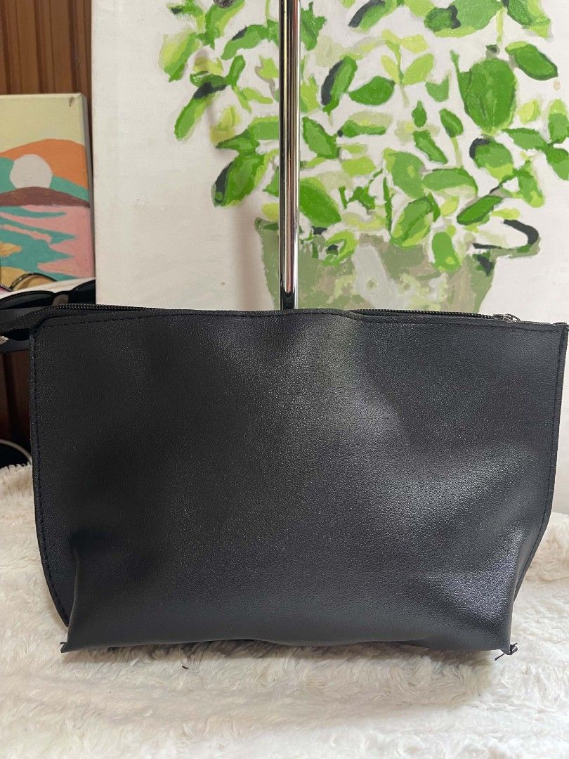 Black pouch bag with zipper closure (Category: Purses & Pouches) located in Naawan. Submitted by twilly.apparel2 (Listing ID 1462911073, Image 1). Description: - Faux leather material - Secure zipper closure at the top - Ideal size for carrying essentials - Lightweight and easy to carry.