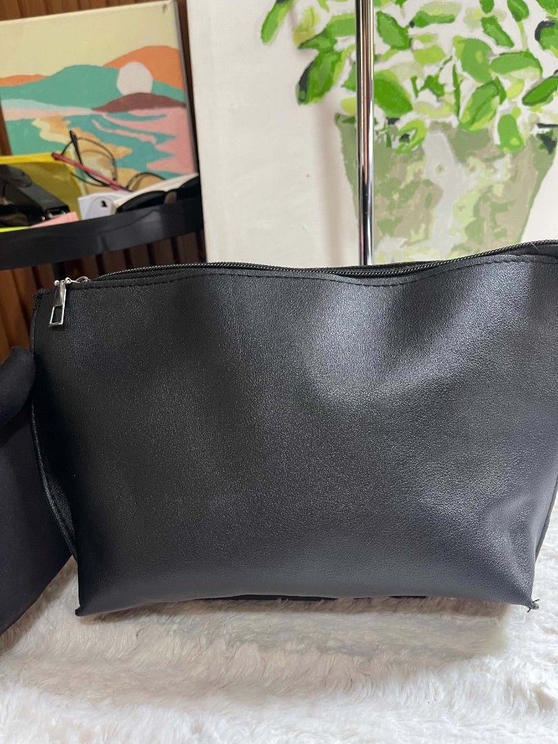 Black pouch bag with zipper closure (Category: Purses & Pouches) located in Naawan. Submitted by twilly.apparel2 (Listing ID 1462911073, Image 2). Description: - Faux leather material - Secure zipper closure at the top - Ideal size for carrying essentials - Lightweight and easy to carry.