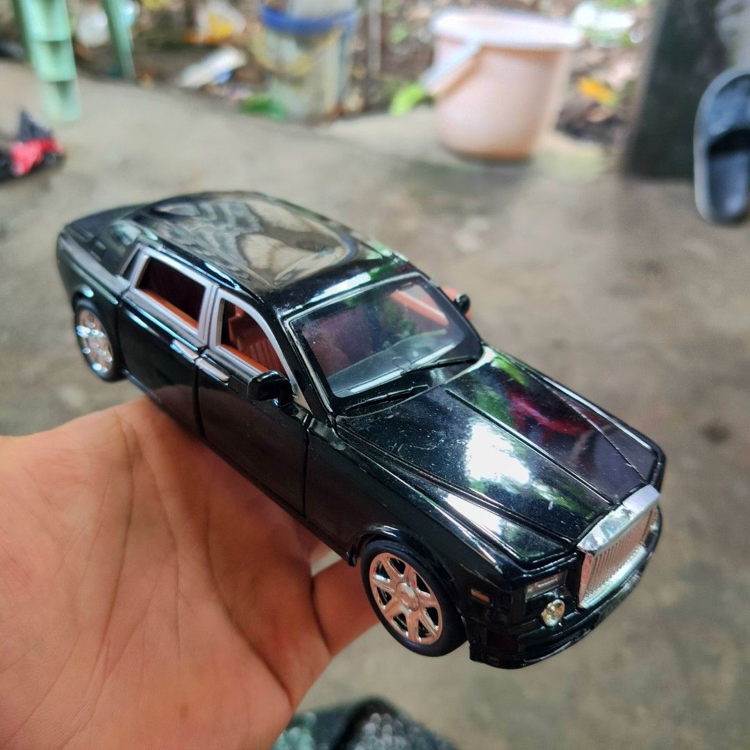 Black Rolls-Royce Phantom Diecast Model Toy Car (Category: Vehicle & Diecast Models) located in Plaridel. Submitted by klayskolektibols (Listing ID 1462981721, Image 1). Description: - Black diecast model of a Rolls-Royce Phantom - Detailed interior with striking orange seats - Realistic wheels and grille for an authentic look - Features the license plate 'M923S' - Approximately 6 inches in length - Ideal for car collectors or as a sophisticated 