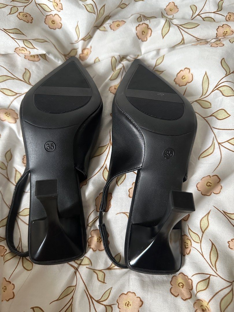 Black Slingback Heels Size 35 (Category: Heels) located in Lipa City. Submitted by chiechums (Listing ID 1462949403, Image 3). Description: - Type: Black Slingback Heels - Size: 35 - Design: Pointed toe - Fit: Elastic strap at the back for a secure fit - Heel: Unique sculpted shape - Style: Perfect for dressing up or down.