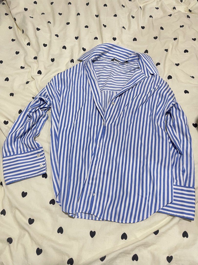 Blue and White Striped Button-Up Shirt (Category: Shirts) located in Manila. Submitted by mallowieee (Listing ID 1463003002, Image 3). Description: - Classic blue and white striped pattern - Long sleeves with button cuffs - Relaxed fit for comfort - Versatile for casual or work attire - Pairs well with jeans or trousers.