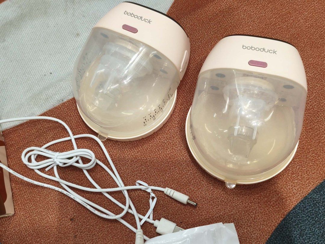 Bobo duck Wearable Breast Pump (Category: Breastfeeding & Bottle Feeding) located in Alicia. Submitted by thriftbagph (Listing ID 1463077904, Image 2). Description: - Pink & clear Bobo duck wearable breast pumps - Rechargeable and portable design - Easy to use and clean - Ideal for mothers on the go - All accessories shown in photos included ( nipple shield , nursing breast pads, breastmilk storage , wearable breast milk collector) - missing adap