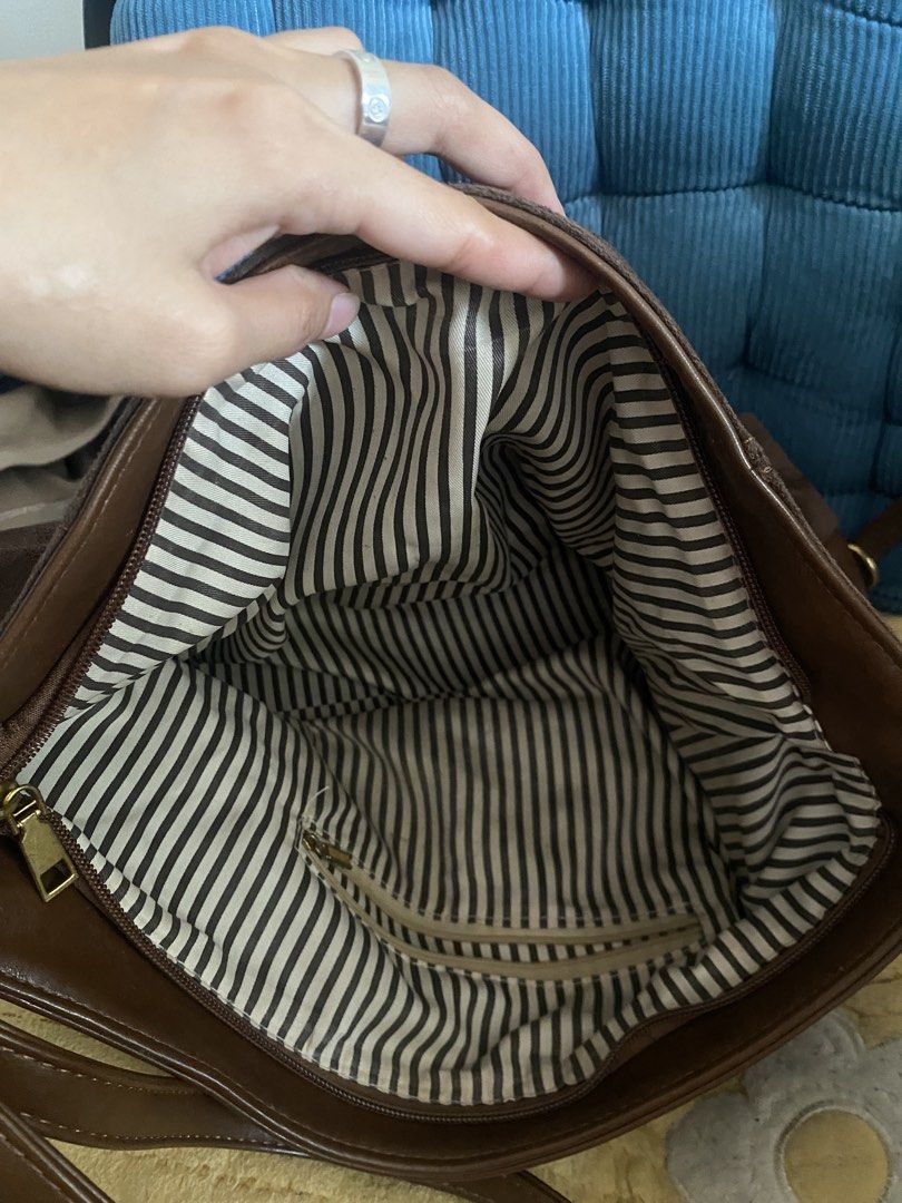 Brown Leather & Suede Shoulder Bag (Category: Shoulder Bags) located in Manila. Submitted by lecurateurofficial (Listing ID 1462926433, Image 3). Description: - Stylish brown shoulder bag - Mix of leather and suede materials - Fun striped interior lining - Convenient inner zip pocket - Adjustable strap for comfort - Plenty of space for your essentials - Ideal for everyday wear Price is negotiable .