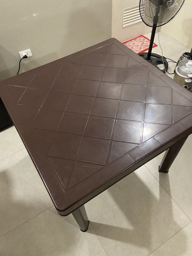 MOVING OUT: Brown Plastic Square Table with Detachable Legs (Category: Tables & Sets) located in Los Banos. Submitted by chieme.011 (Listing ID 1463084760, Image 2). Description: Material: Sturdy brown plastic table Pattern: Square top with diamond pattern • Detachable legs for easy storage and transport • Versatile: great for dining, study, or as a side table.
