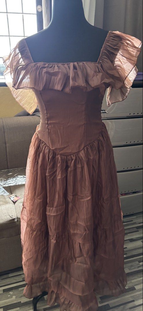 Brown Ruffled Off-Shoulder Dress (Category: Dresses) located in Caloocan City. Submitted by niki.niki. (Listing ID 1463053490, Image 1). Description: - Elegant brown dress with a unique ruffled off-shoulder neckline. - Features a stylish tiered skirt with delicate ruffles. - Made from a flowy and airy fabric, perfect for staying comfortable. - Ideal for parties, events, or any special occasion. - Stand out with this one-of-a-kind design..