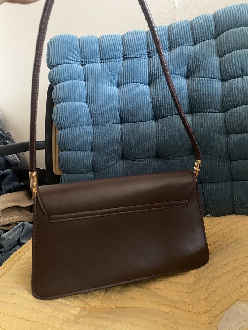 Brown Shoulder Bag with Gold Hardware (Category: Luxury Bags & Wallets) located in Manila. Submitted by lecurateurofficial (Listing ID 1462926319, Image 2). Description: - Cute brown shoulder bag - Simple design with a curved flap - Gold hardware details on the strap - Two main interior compartments - Ideal for everyday use and carrying essentials All prices is negotiable .