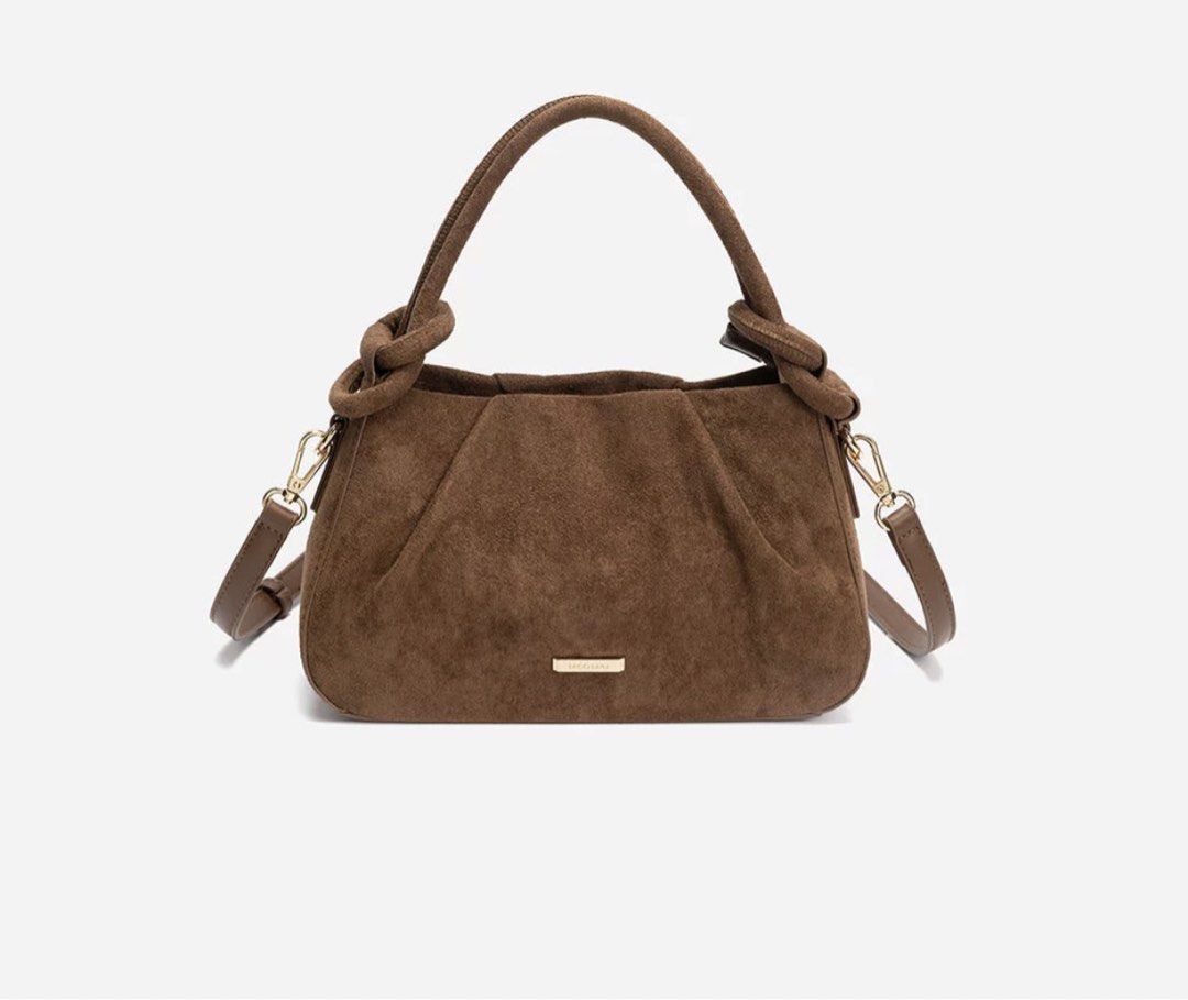 Brown Suede Knot Handle Shoulder Bag (Category: Shoulder Bags) located in Cavite. Submitted by ekasbeautyandtoysroom (Listing ID 1462932386, Image 1). Description: - Cute brown suede shoulder bag - Features a stylish knotted handle - Includes a detachable crossbody strap for versatile wear - Accented with elegant gold hardware on the front - Spacious interior, ideal for your daily essentials - Perfect for casual outings and everyday use.