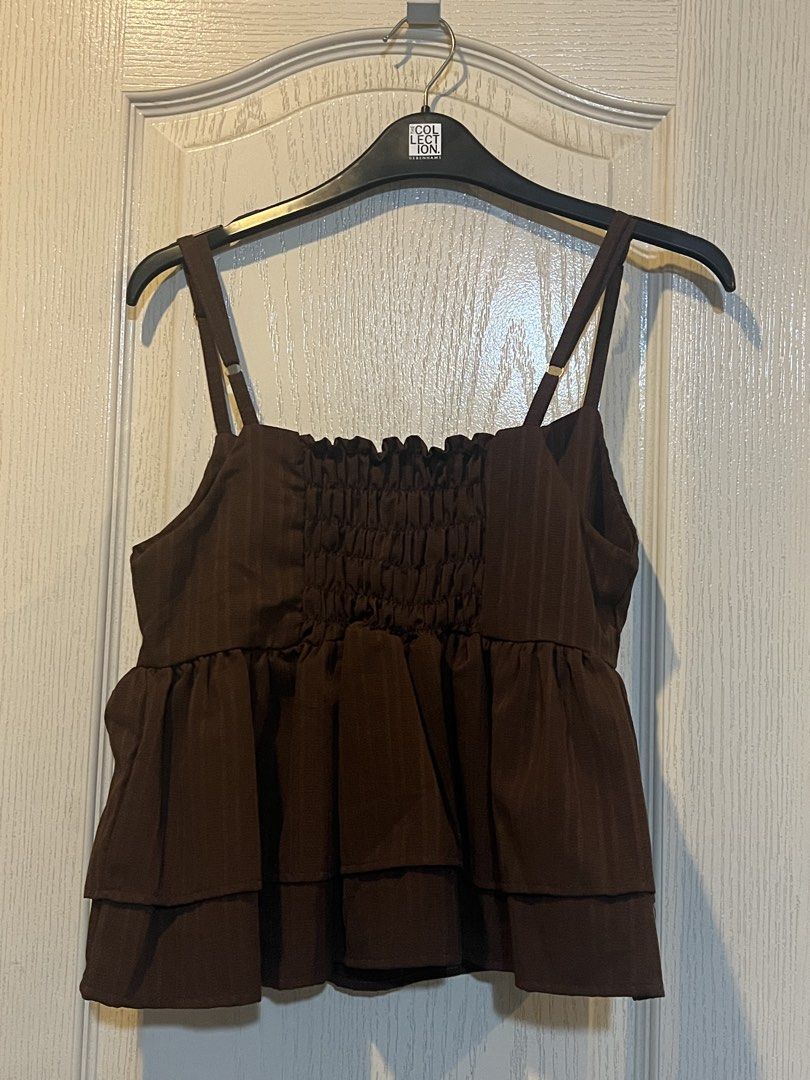 Brown Tiered Camisole Top (Category: Sleeveless) located in Quezon City. Submitted by sunusales (Listing ID 1463023262, Image 2). Description: - Cute brown camisole top - Square neckline with adjustable straps - Smocked bust detail for a flattering fit - Tiered ruffle hemline for a playful look - Versatile: pairs well with jeans or skirts - Ideal for casual outings or dressing up gcash, maribank j&t, sdd (grab/lalamove - to be booked by buyer).