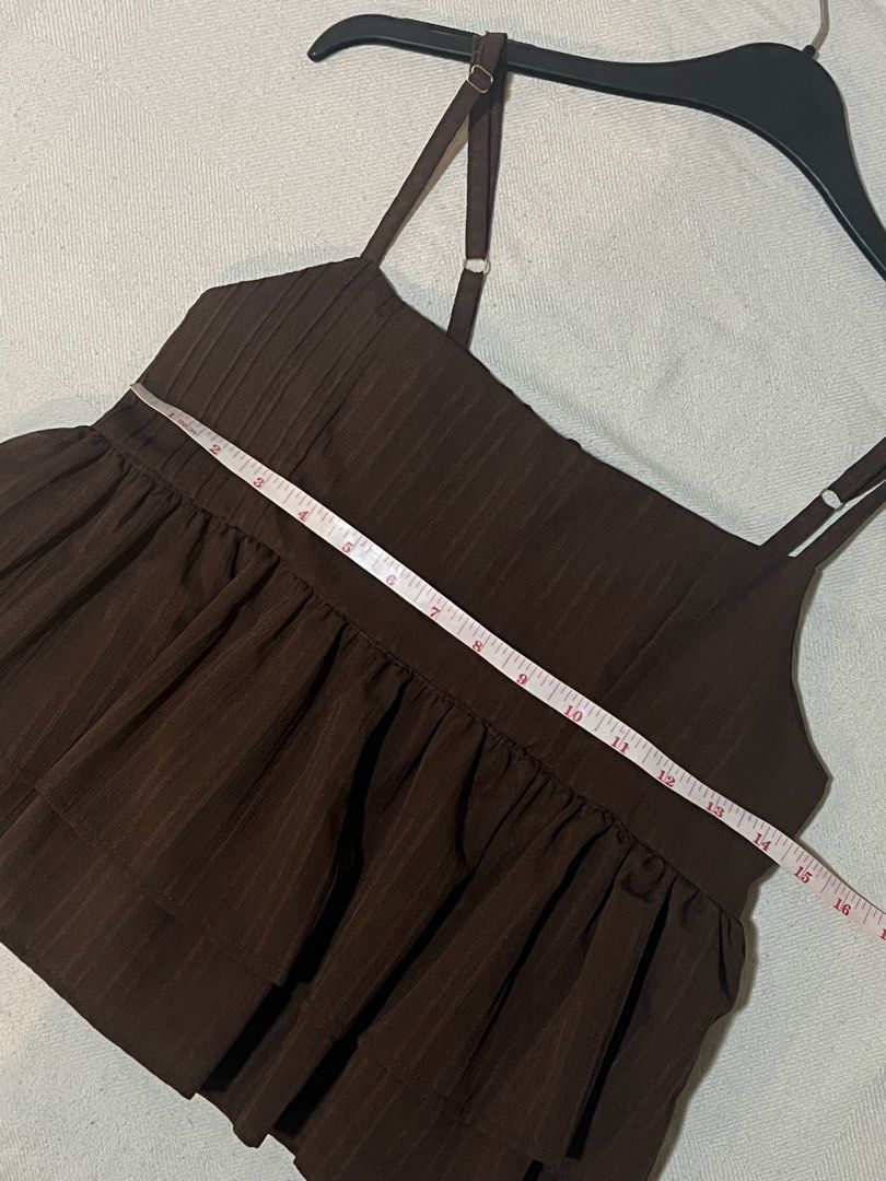 Brown Tiered Camisole Top (Category: Sleeveless) located in Quezon City. Submitted by sunusales (Listing ID 1463023262, Image 3). Description: - Cute brown camisole top - Square neckline with adjustable straps - Smocked bust detail for a flattering fit - Tiered ruffle hemline for a playful look - Versatile: pairs well with jeans or skirts - Ideal for casual outings or dressing up gcash, maribank j&t, sdd (grab/lalamove - to be booked by buyer).