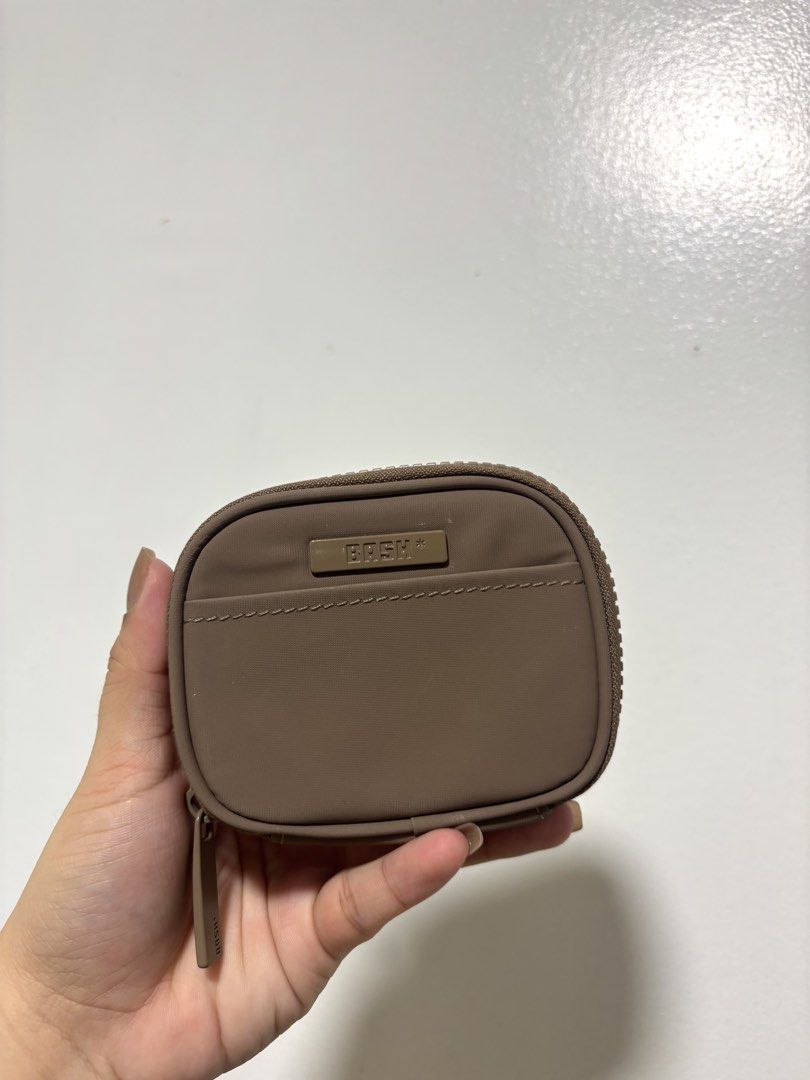 BRSH Pouch Coin Bag Card Holder (Category: Purses & Pouches) located in Guiguinto. Submitted by 2nd.stuff. (Listing ID 1462909183, Image 1). Description: - BASH small pouch - Neutral brown color - Ideal for coins, cards, or small essentials - Durable material - Secure zip closure - Convenient D-ring clip for attaching to bags.