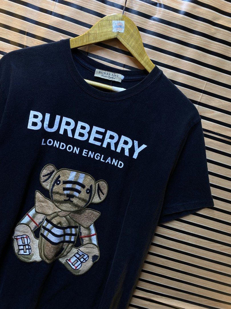 BURBERRY LONDON “Embroid Teddy bear” Tee (Category: Tshirts & Polo Shirts ) located in Makati City. Submitted by drip.poww (Listing ID 1462940368, Image 2). Description: - Burberry - Color: Black - Size: Large - Dimes: 23x26 - Authentic - No side stitch - Excellent condition - Need wash, fresh from bale - Material: 100% Cotton Please don’t expect too much—these are thrifted (ukay) items. 😊 !!STILL NEGOTIABLE!!.