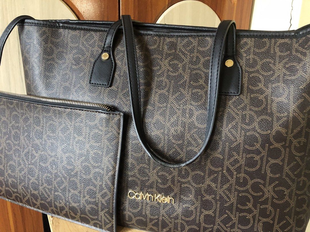 Calvin Klein Monogram Tote Bag with Pouch (Category: Luxury Bags & Wallets) located in Makati City. Submitted by mitchi_koy28 (Listing ID 1462950279, Image 1). Description: - Brown Calvin Klein tote bag - All-over CK monogram print - Includes matching zippered pouch - Gold tone hardware - Interior zippered pockets - Ideal for everyday use or travel - Received as a gift.