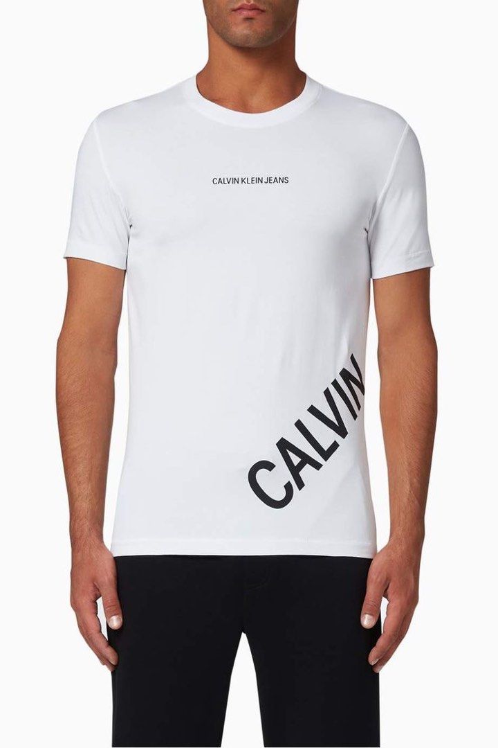 Calvin Klein Stretch Logo T-Shirt (Category: Activewear) located in Quezon City. Submitted by 1106_collective (Listing ID 1462954400, Image 1). Description: Size: XXL Condition: 9/10 Material: 95% Cotton / 5% Elastane Made in: Cambodia Flaw / Defect: Minor yellowing on the inner side part of body and on the inner hem Dimension Width: 20.5” Length: 29” Shoulder: 17.5” Sleeve: 7.5”.