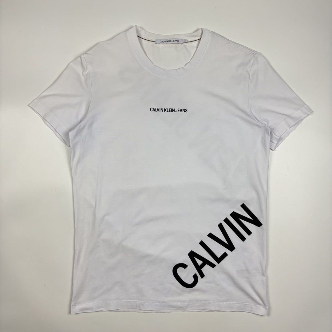 Calvin Klein Stretch Logo T-Shirt (Category: Activewear) located in Quezon City. Submitted by 1106_collective (Listing ID 1462954400, Image 2). Description: Size: XXL Condition: 9/10 Material: 95% Cotton / 5% Elastane Made in: Cambodia Flaw / Defect: Minor yellowing on the inner side part of body and on the inner hem Dimension Width: 20.5” Length: 29” Shoulder: 17.5” Sleeve: 7.5”.