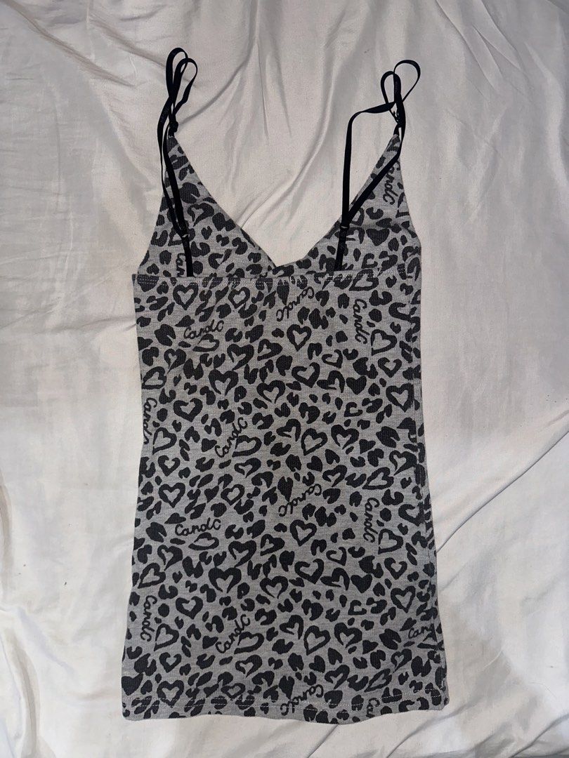 Candle Grey Leopard Heart Print Ribbed Tank Top (Category: Sleeveless) located in Manila. Submitted by etain.xo (Listing ID 1463010131, Image 2). Description: - Grey ribbed tank top - Black leopard and heart print - Adjustable spaghetti straps - Estimated size: Small to Medium - Versatile for layering or wearing solo.