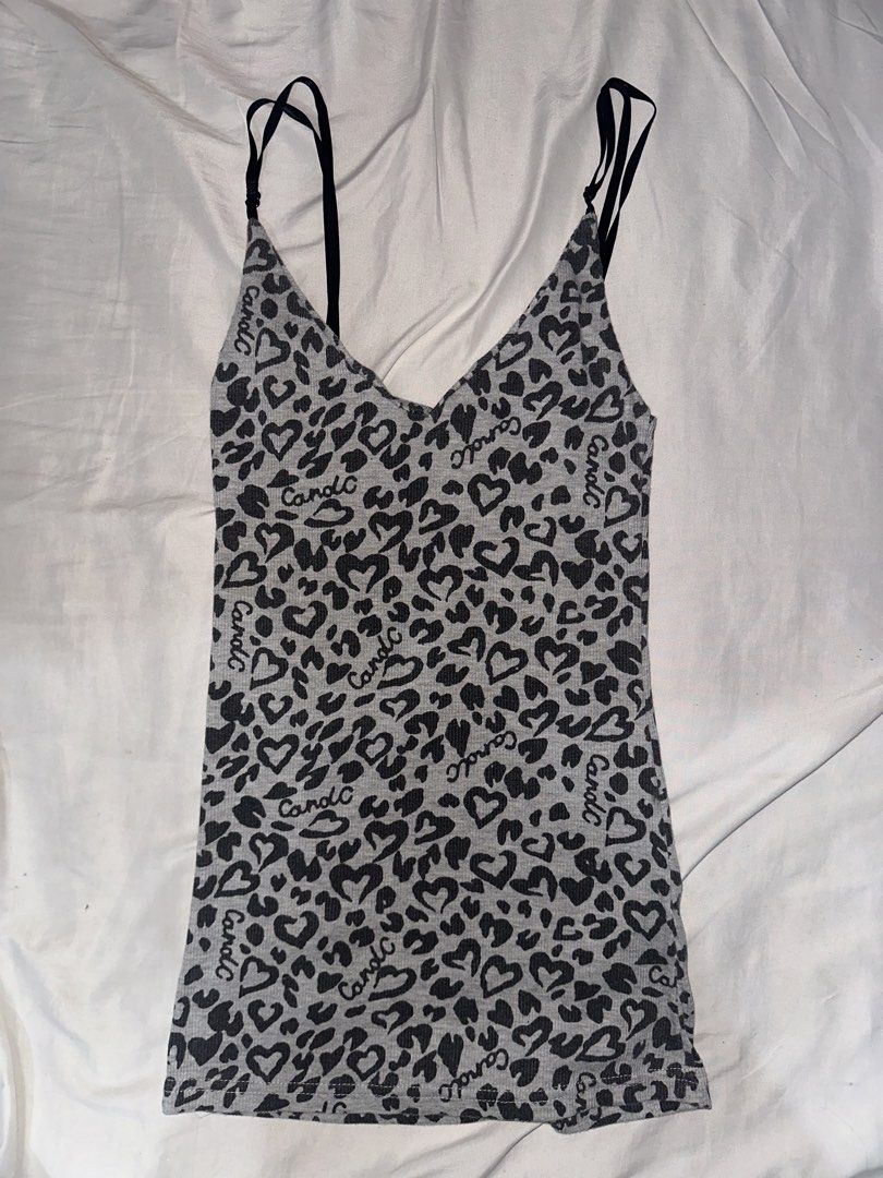 Candle Grey Leopard Heart Print Ribbed Tank Top (Category: Sleeveless) located in Manila. Submitted by etain.xo (Listing ID 1463010131, Image 1). Description: - Grey ribbed tank top - Black leopard and heart print - Adjustable spaghetti straps - Estimated size: Small to Medium - Versatile for layering or wearing solo.