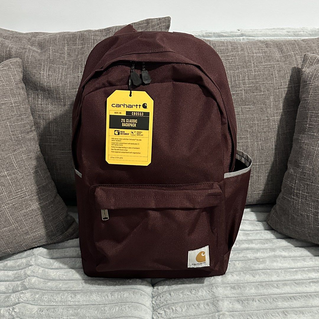 Carhartt CB0553 21L Classic Backpack - Maroon (Category: Backpacks) located in Agdangan. Submitted by kiiiiingg (Listing ID 1463080427, Image 1). Description: - Carhartt 21L Classic Backpack - Color: Maroon - Material: Durable 600-denier fabric, water repellent - Main compartment fits up to a 15-inch laptop - Front zippered compartment with elastic strap - Reflective piping on the sides for visibility - Side pockets for water bottles - Built for 