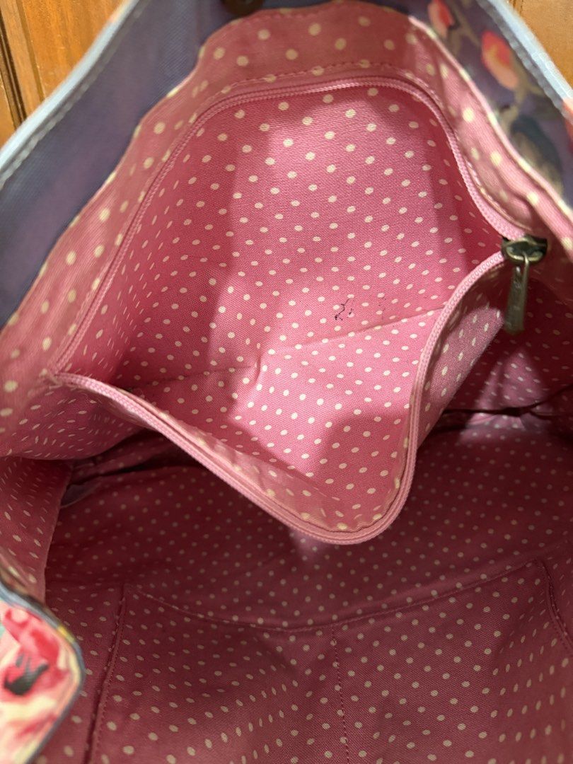 Cath Kidston Floral Tote Bag (Category: Tote Bags) located in Manila. Submitted by prelovedbylkt (Listing ID 1463031451, Image 3). Description: - Brand: Cath Kidston - Style: Floral Tote Bag - Color: Blue base with vibrant floral print - Interior: Pink polka dot lining with multiple pockets - Closure: Button at the top - Ideal for: Everyday use, travel bag - Issue: Stains on exterior .